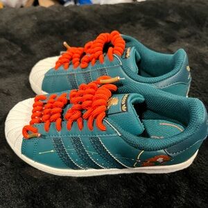 Adidas X Disney
Princesses Superstar Shoes with orange laces.